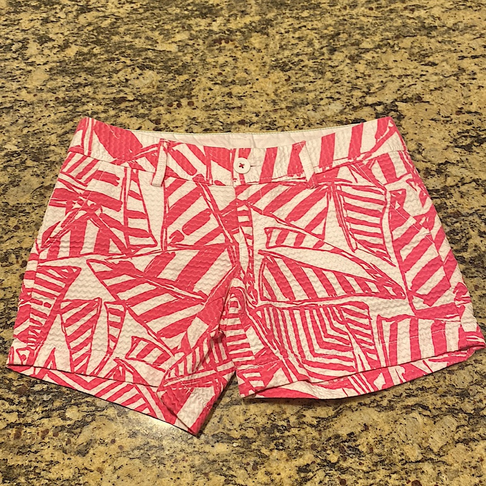 Lilly Pulitzer Callahan Shorts in a size 0. They’re white with pink detailing.